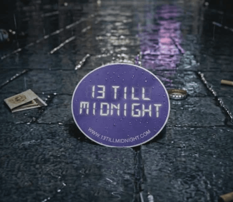 13 till midnight  sticker on a wet road